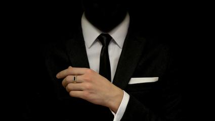 A headless figure is wearing a suit 