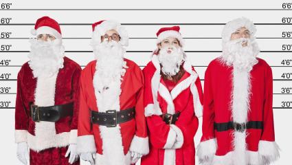 Four people dressed as Santa in a police line up