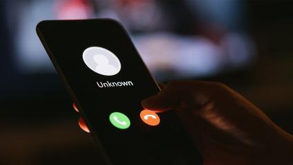 A smartphone showing a phone call from an unknown number