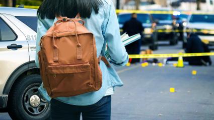 A stock image of a student looking at a crime scene