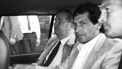 John Palmer in the back of a police car