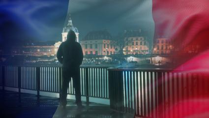 A hooded figure lurking on the banks of the Seine