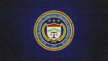 The ATF (Bureau of Alcohol, Tobacco, Firearms and explosives) logo painted on a brick wall.