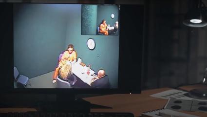 A monitor showing CCTV footage from Henry Steiger's interrogation