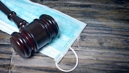 A gavel on a surgical face mask