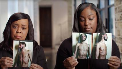 Two women hold malnourished photos of their family member in Parchman 