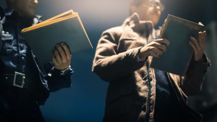 Two detectives looking at files