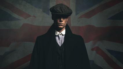 1920s English gangster in a flat cap