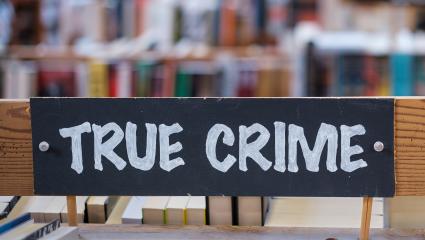 A 'true crime' sign in a library