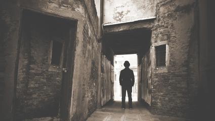 A man walking out from the shadows