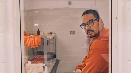 Abner looks through the door of his cell