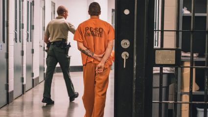 An inmate wearing an orange jumpsuit