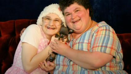 Gypsy Rose and her mother hold a small dog