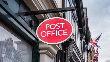 A Post Office sign on a British street