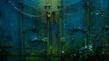 An ominous shipping container with a padlock across the front