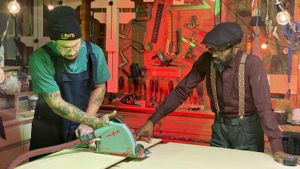 Taury Meade uses a buzz saw while his dad, Raphael, watches on