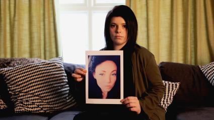 Alice holding a picture of her murdered cousin, Lea Ware