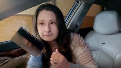 Gypsy Rose Blanchard using her phone on loudspeaker while sitting in the passenger seat of a car
