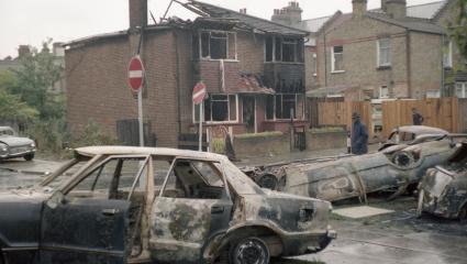 Burned out cars on the street the day after the Broadwater Farm Riots