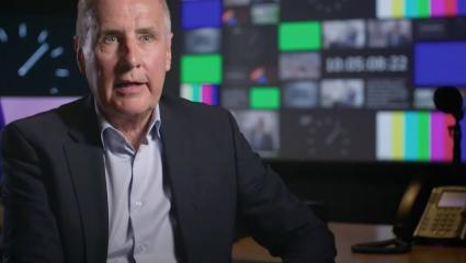 Dermot Murnaghan sitting in a TV gallery