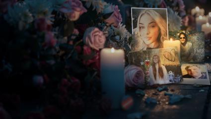 Flowers and candles are laid at a tribute to innocent people who have died