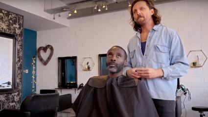 Nat Asabere gets his hair cut by James Busby
