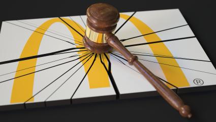 A judge's gavel smashes the McDonald's logo
