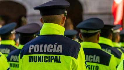 Back view of the municipal police of Puebla with the "Policia Municipal" logo emblem on uniform