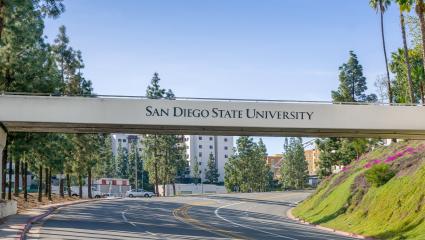 A bridge over a road that reads 'San Diego State University'