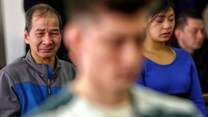 Hung Bui and Anny Bui, the father and sister of Anna Bui, become emotional at the sentencing hearing of Allen Ivanov. Allen Ivanov stands in the foreground