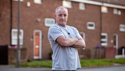 Paul Massey standing with his arms crossed