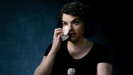 Lejla Dauti wiping a tear with a tissue
