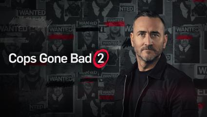 'Cops Gone Bad 2' - Will Mellor standing in front of 'Wanted' posters