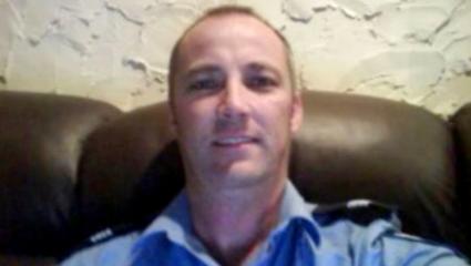 Adrian Trevor Moore takes a selfie while wearing his police uniform