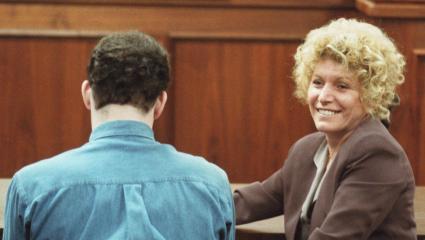 Leslie Abramson smiles in court while Erik Menendez sits with his back to the camera