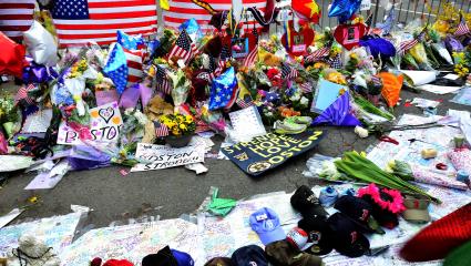 Flowers, signs and balloons are left on the floor in memory of the Boston Marathon bombing victims