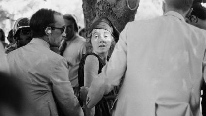 Lynette 'Squeaky' Fromme looks at a camera while being arrested for the attempted assassination of President Ford