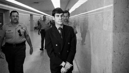 Tex Watson is led back to jail from the courthouse while wearing handcuffs