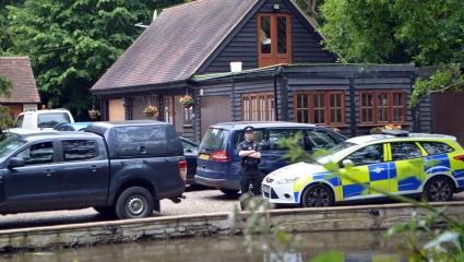 Police cars outside John Palmer's home in Essex following his murder
