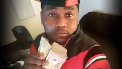 Rubbin Sarpong posing with a wad of money