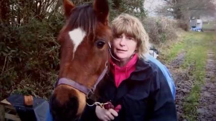 Penny Davis having her photo taken next to a horse