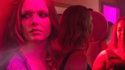 Women under pink lights in a reconstruction