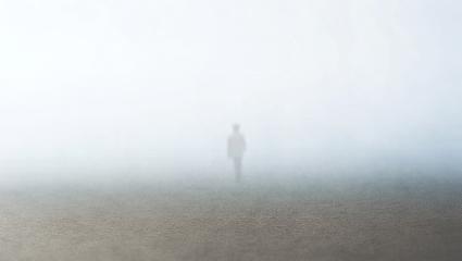The faint outline of a person disappearing into a foggy mist