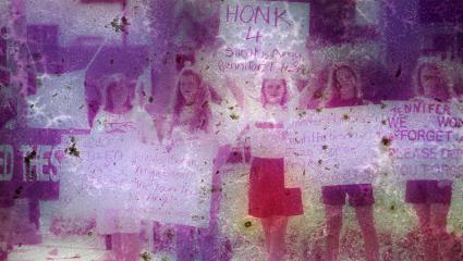 Young women hold up signs of remembrance, and frustration with lack of arrests in the 'Yogurt Shop Murders' case