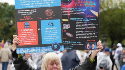 A woman holds up a sign outlining the dangers of fentanyl in Washington DC