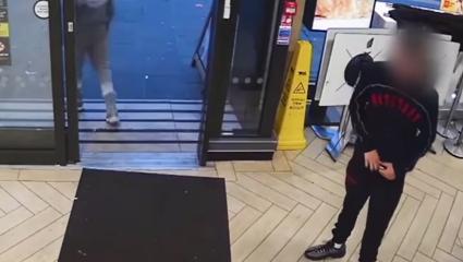 CCTV of a teenage boy in McDonalds. His face is blurred
