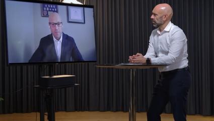 Mike Lacorte interviewing John Rowan on a television screen