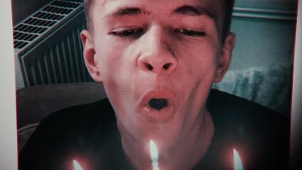 Mikey Roynon blowing out candles on a birthday cake