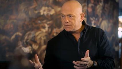 Ross Kemp gestures with his hands while talking to someone out of frame