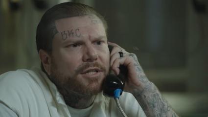 Adam Williams speaking on a prison phone during an interview